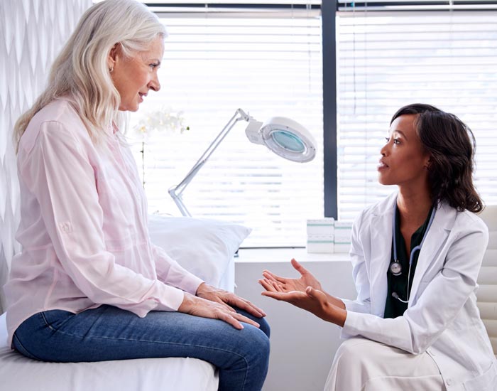 middle aged woman talking to doctor