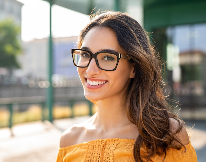 A happy girl wearing glasses